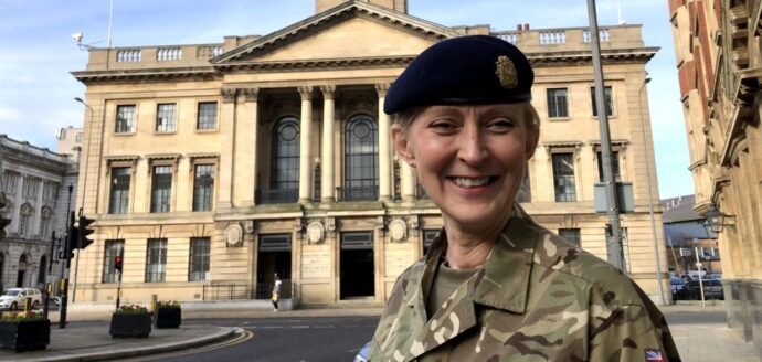 Female in front of Hull Civic Hall in army dress